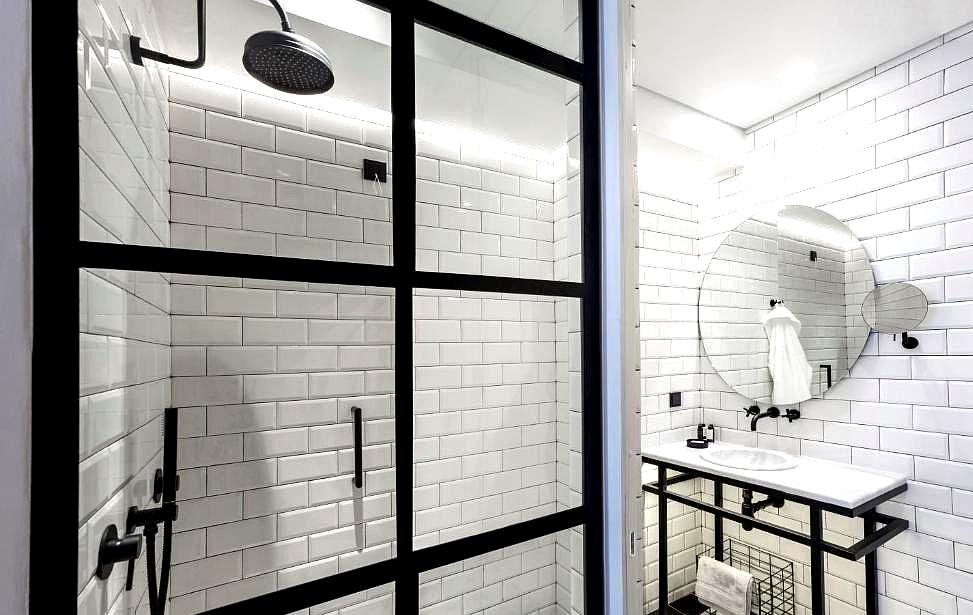 contemporary bathroom with glass shower and subway tiles