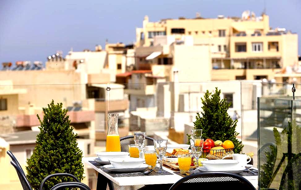 rooftop terrace with breakfast table and city view