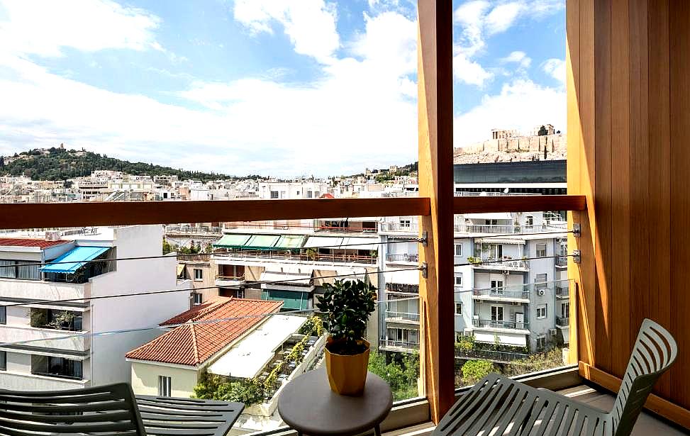 room balcony with city and acropolis view