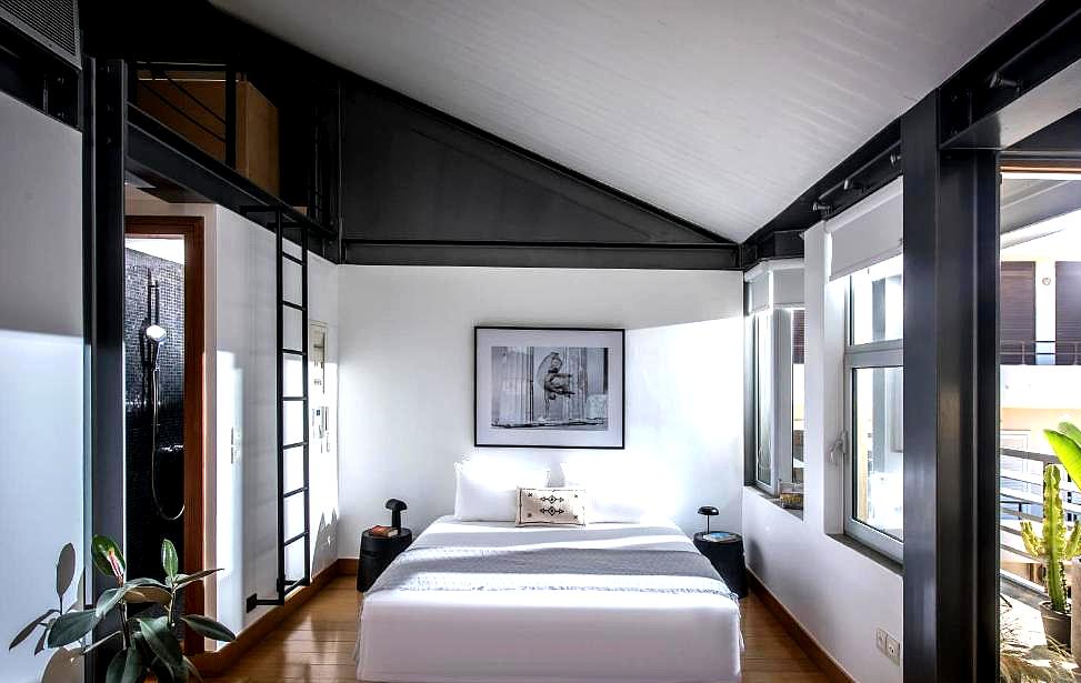 sleek loft bedroom with black accents