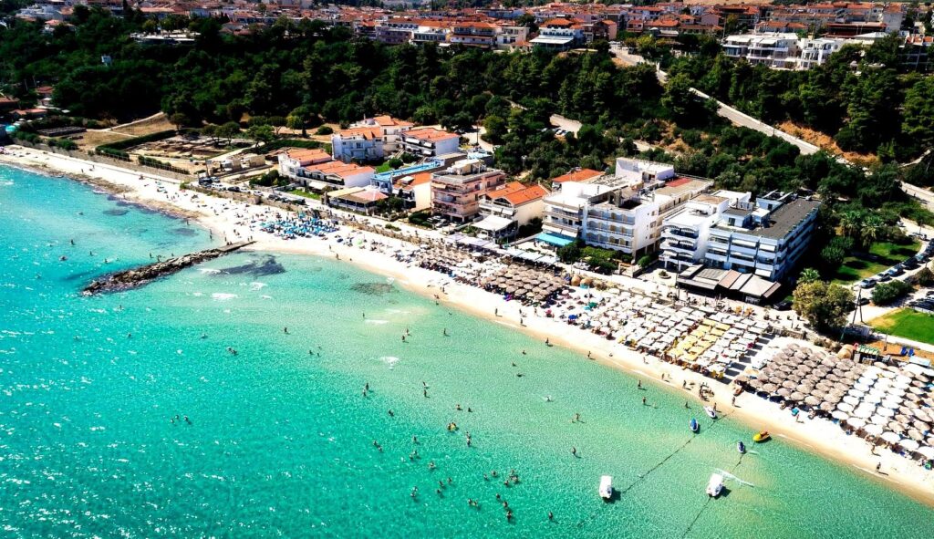 Kallithea Beach is a vibrant sandy beach with lively bars, crystal clear waters, and stunning sunset views