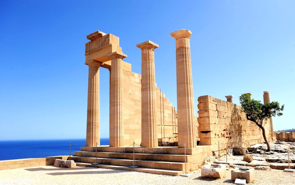 Lindos Acropolis is an ancient citadel on a cliff overlooking the sea, featuring the Temple of Athena and stunning views