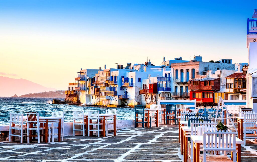 Little Venice in Mykonos is a charming area with colorful houses overhanging the sea, reminiscent of Venice