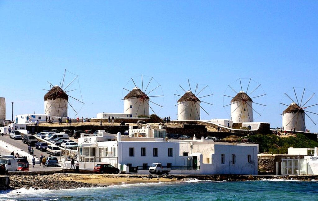 The Mykonos Windmills are iconic structures standing tall on a hill overlooking Mykonos Town, a symbol of the island's history