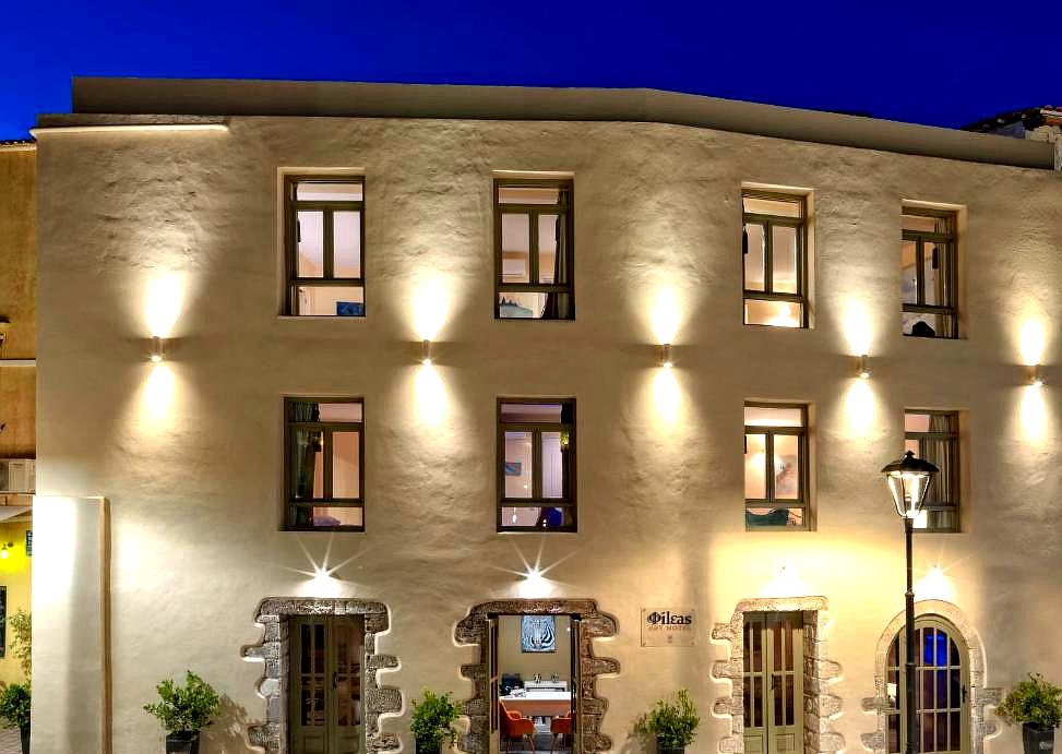 accessible hotel front facade at night with lit windows