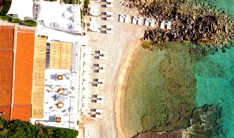 aerial view of beachfront resort with crystal clear water