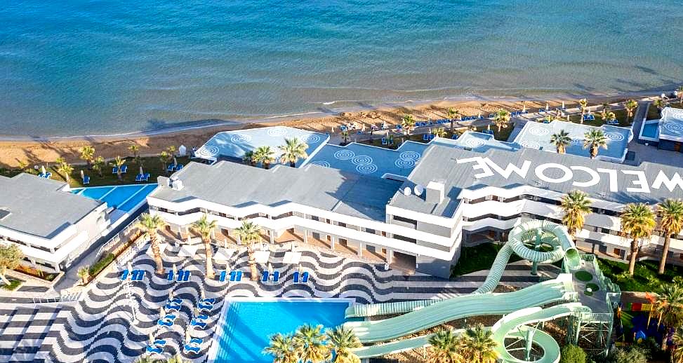 aerial view of beachfront resort with pools and water slides