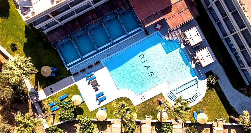 aerial view of outdoor pool and sunbeds at hotel