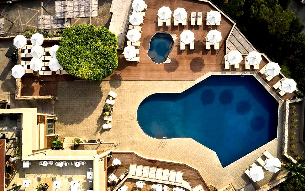 aerial view of outdoor pool area with sun loungers