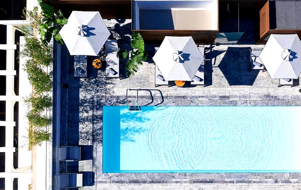 aerial view of pool with cabanas