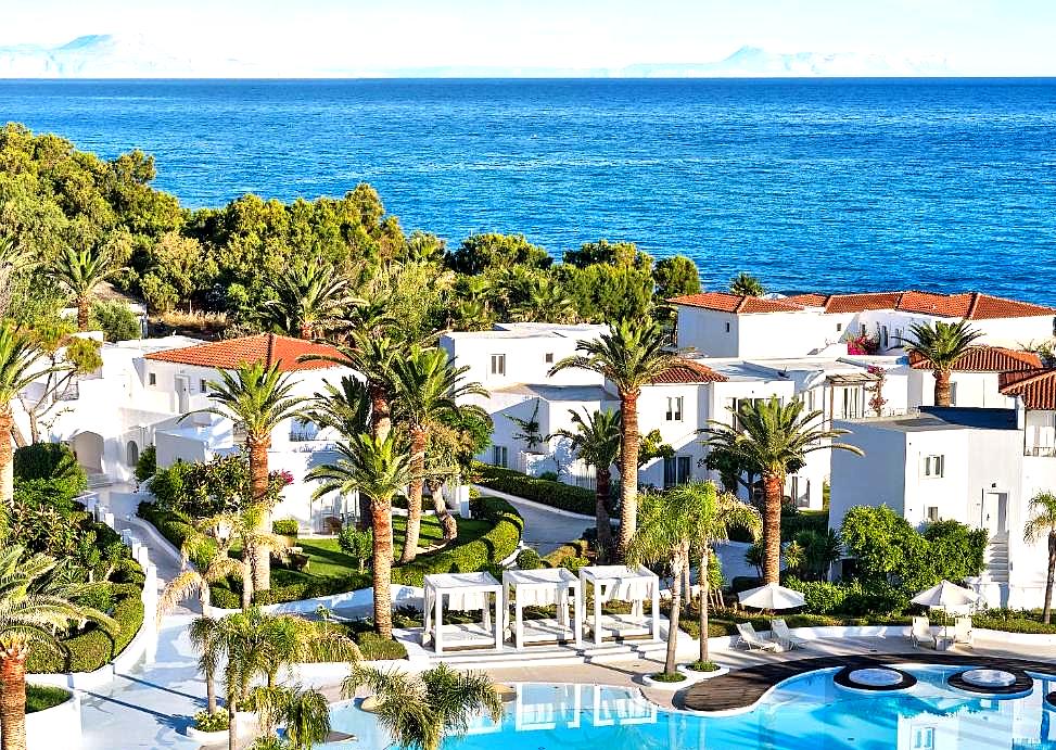 aerial view of resort with lush gardens and sea view