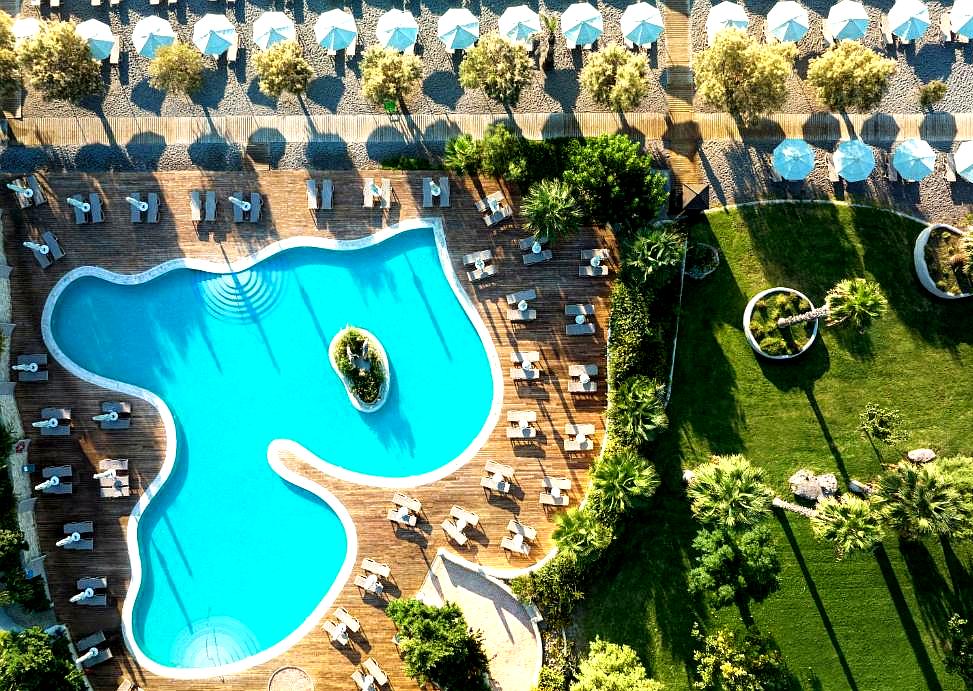 aerial view of swimming pool with cabanas and garden