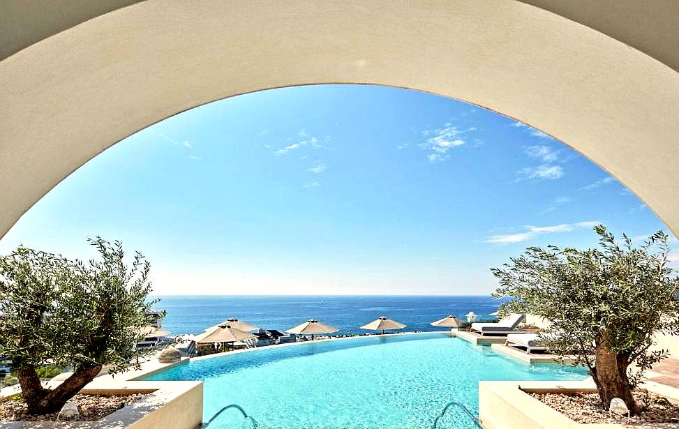 archway framing sea view infinity pool