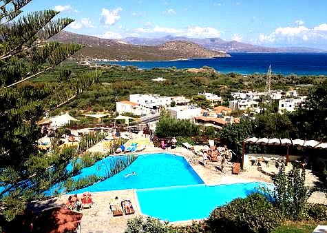 arge swimming pool with sea view and sunbeds