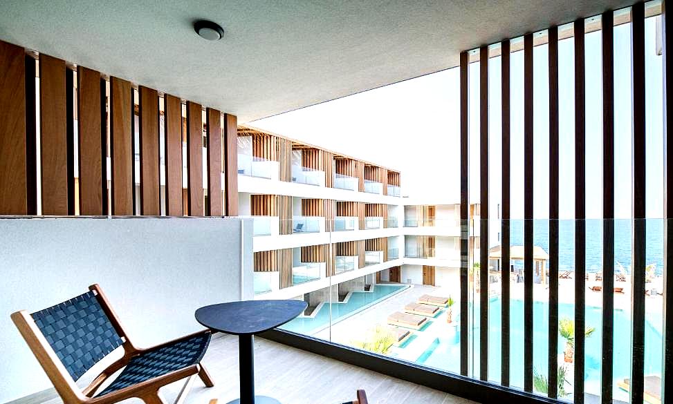 balcony overlooking pool and sea