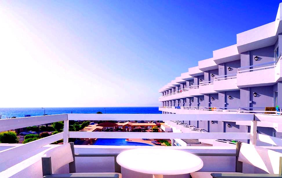 balcony view with sea and poolside rooms