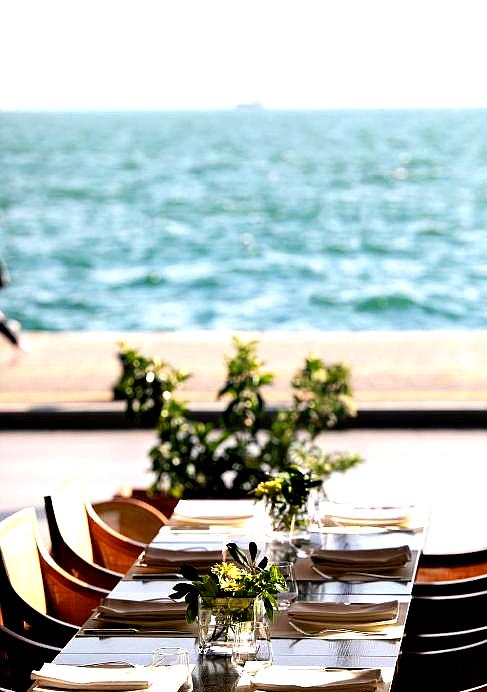 beachfront dining with sea view and elegant table setting