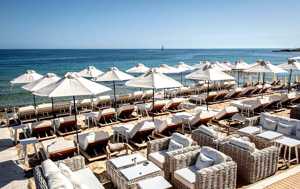 beachfront loungers with sea view and umbrellas