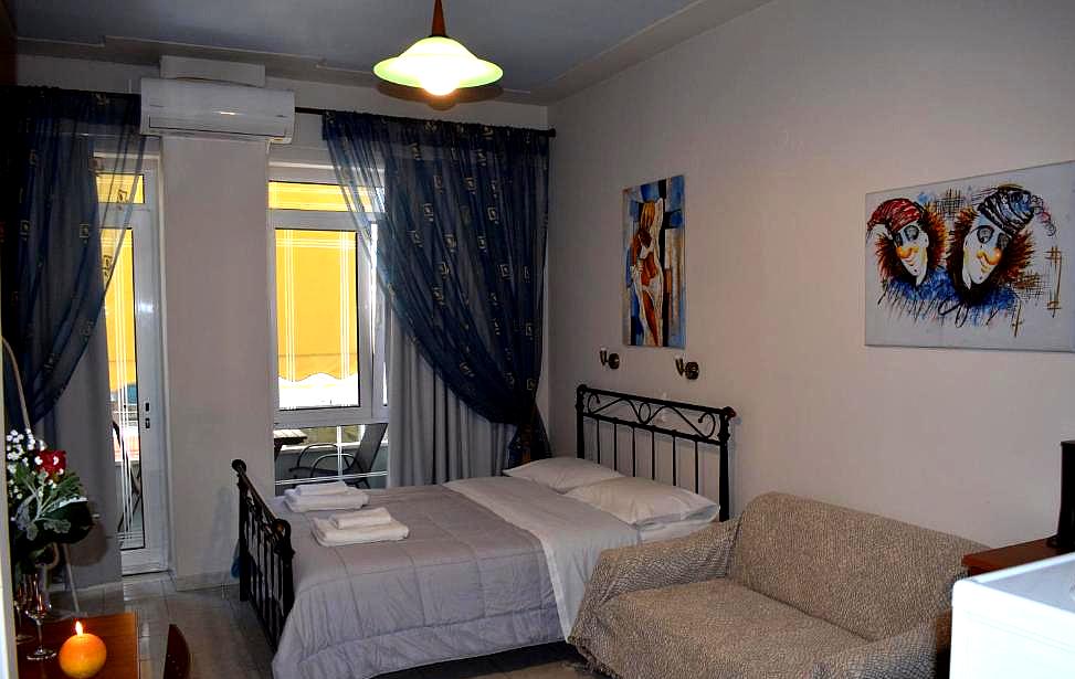 bedroom with air conditioning and small balcony