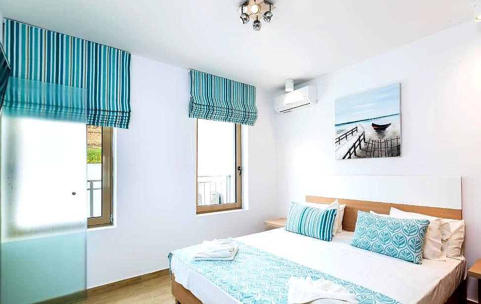 bright bedroom with coastal theme and large windows