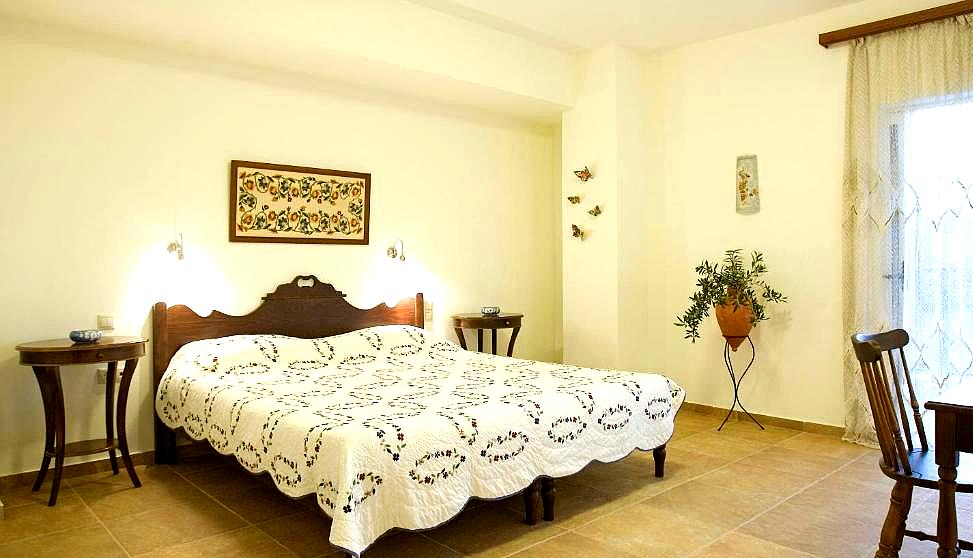 bright bedroom with floral bedspread and classic wooden furniture