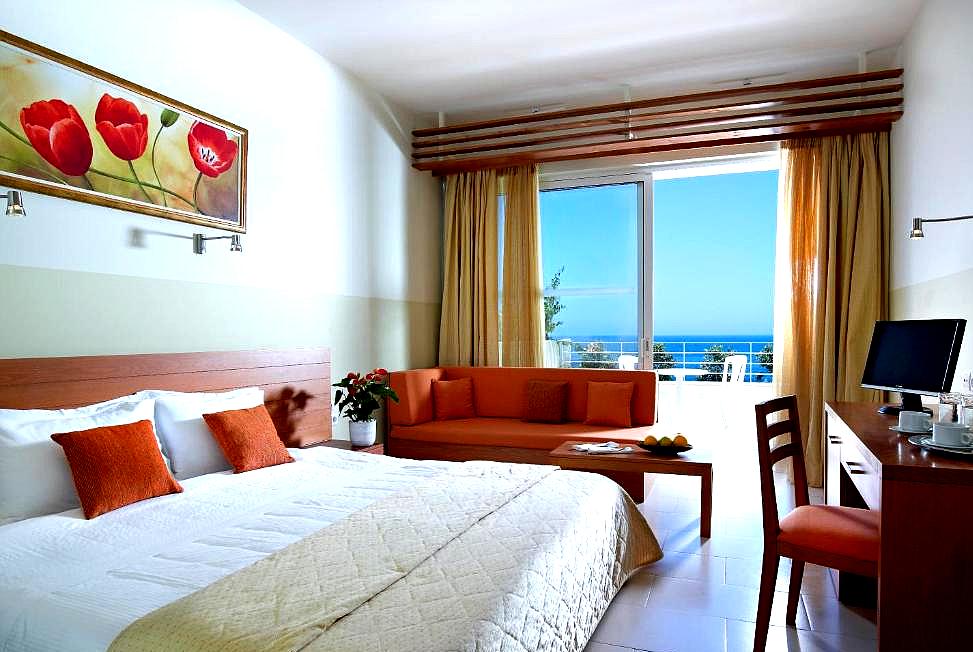 bright hotel room with sea view and vibrant decor