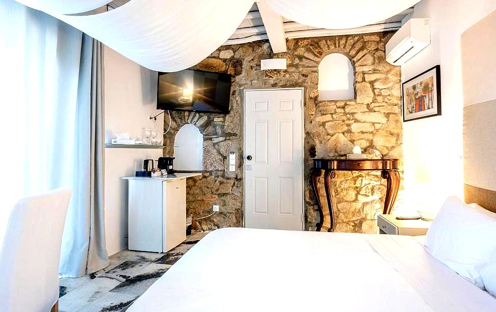 charming bedroom with exposed stone walls