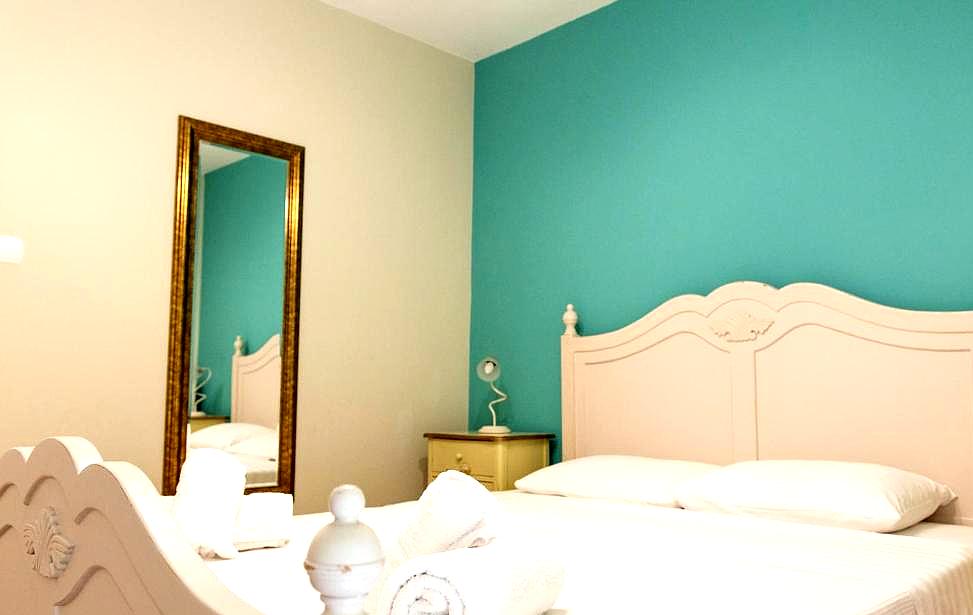 charming bedroom with turquoise accent wall