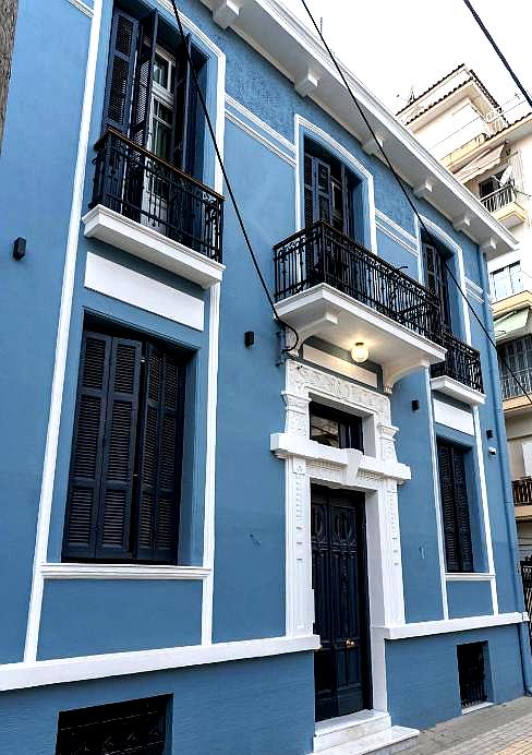 charming blue hotel exterior with balconies