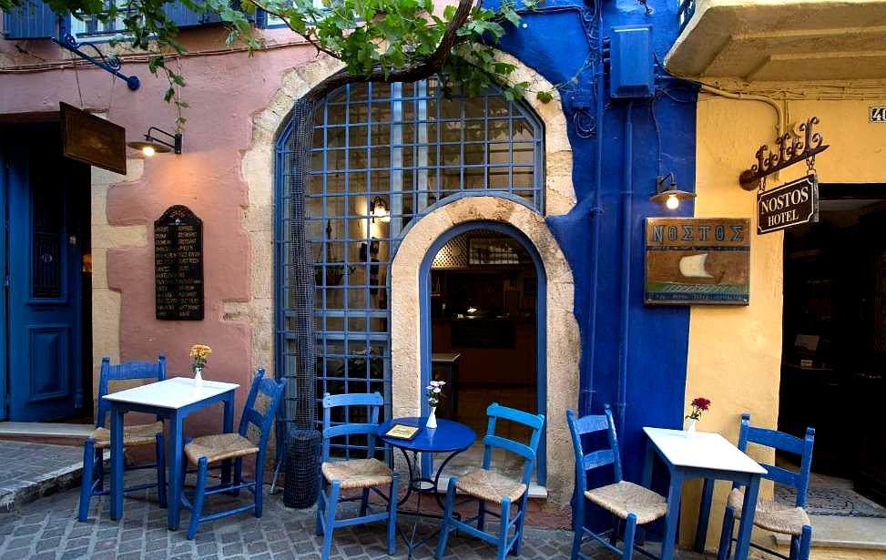 charming outdoor patio with blue furniture and vine covered walls