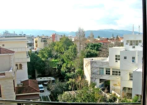 city and mountain view from rooftop terrace