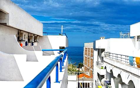 city view from hotel balcony with sea in background