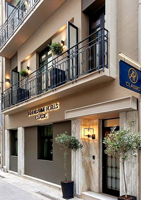 classic hotel facade with balconies and warm lighting