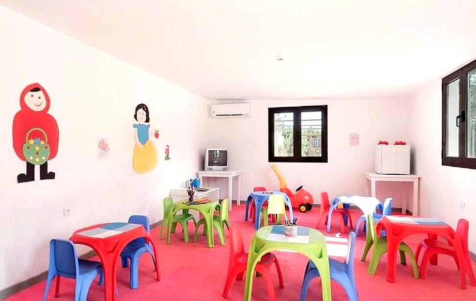 colorful kids playroom with toys and small tables