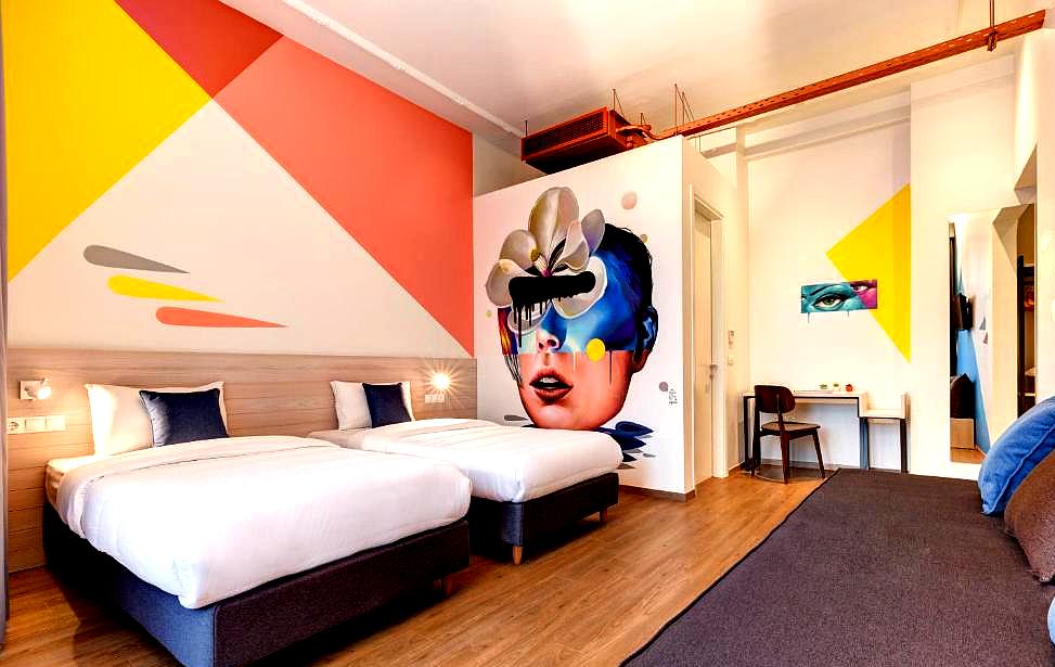 colorful modern room with twin beds and vibrant wall art