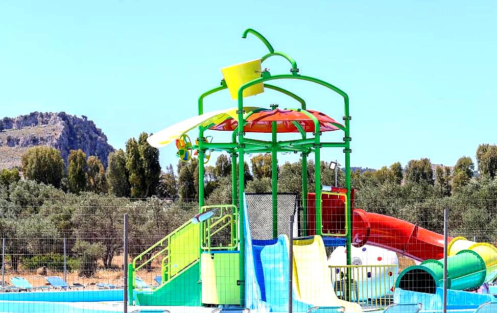 colorful water slide play area in outdoor pool for kids