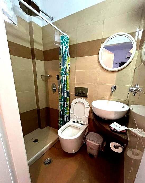 compact bathroom with shower and toilet