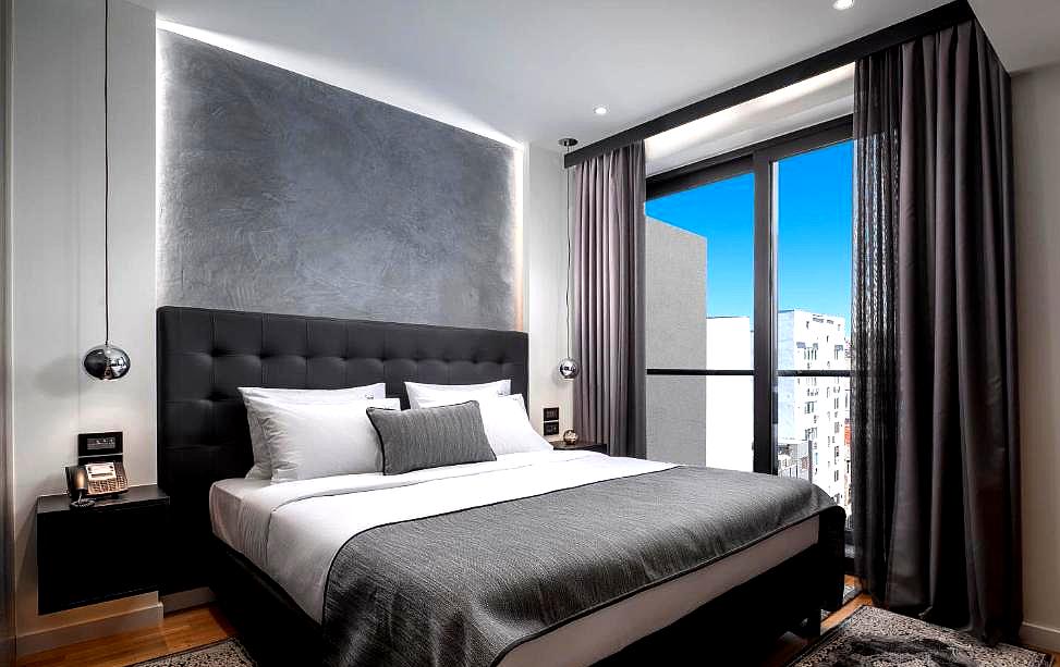 contemporary bedroom with balcony and gray accents