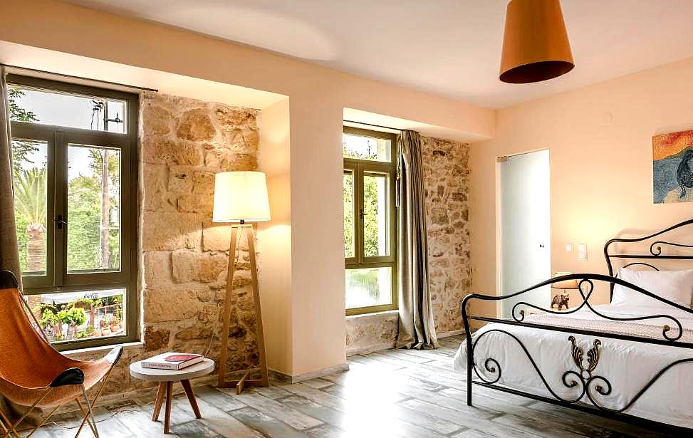 cozy bedroom with stone wall and iron bed frame