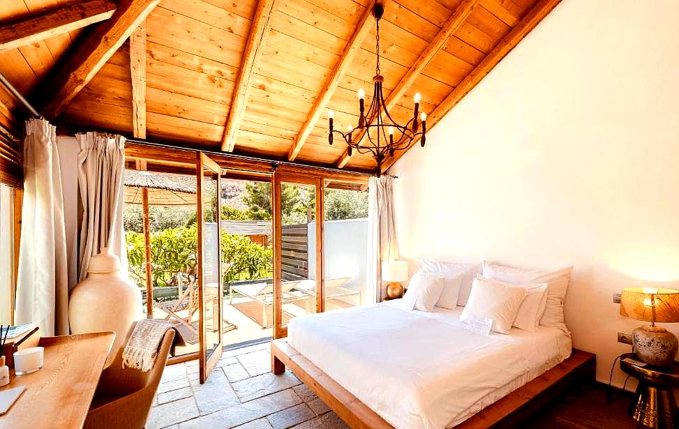 cozy bedroom with wooden ceiling and outdoor access