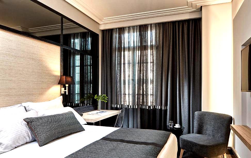 cozy hotel room with dark curtains and modern furnishings