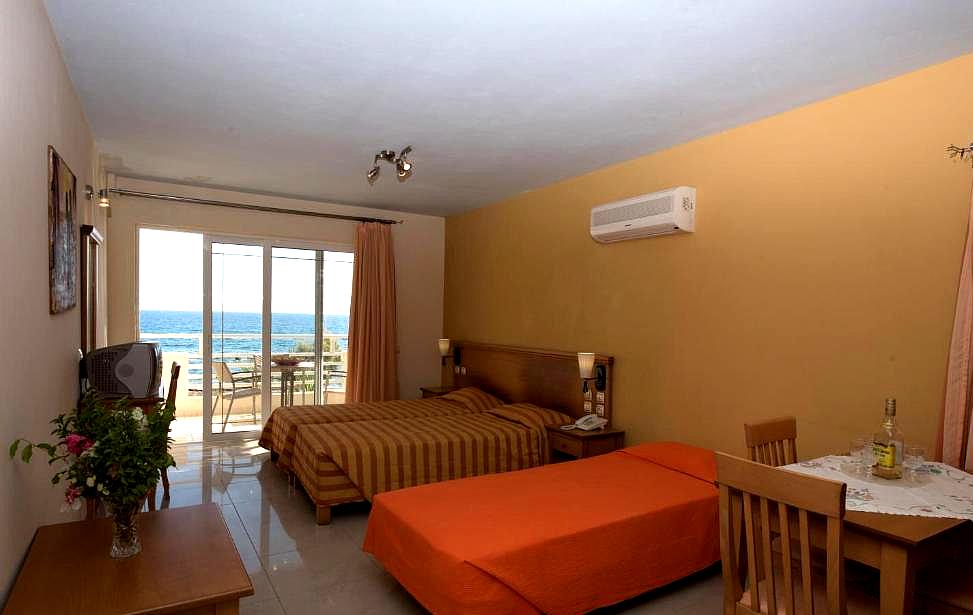 cozy hotel room with sea view balcony and double bed