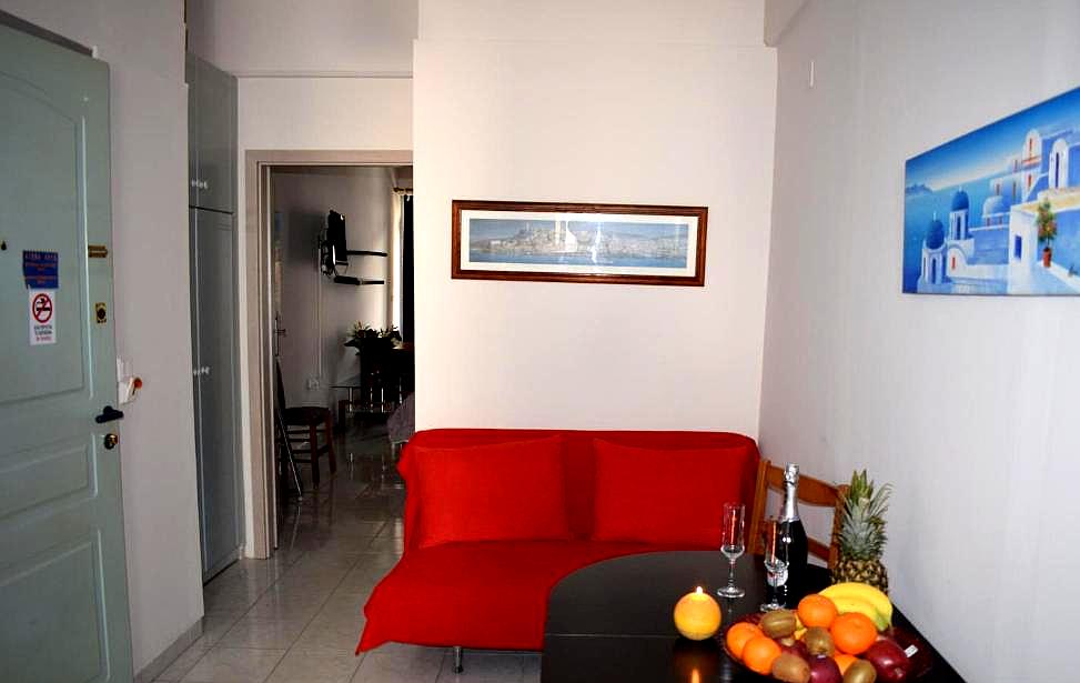 cozy living space with red sofa and fruit plate