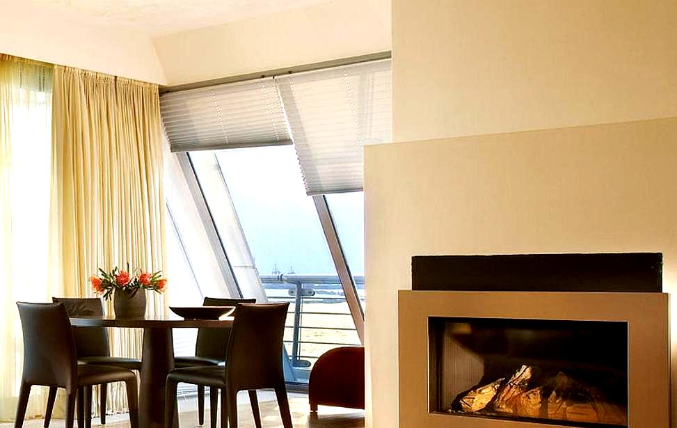 cozy suite with fireplace and sea view from large windows