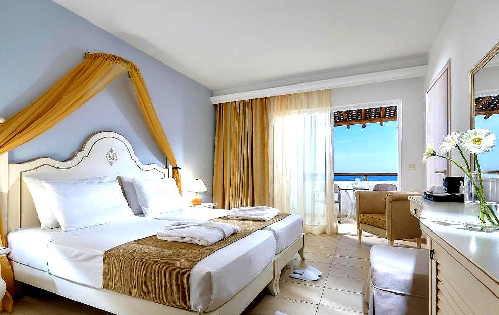 elegant bedroom with balcony and sea view