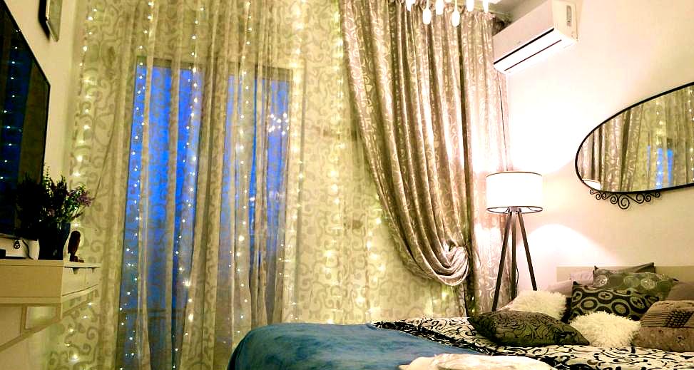 elegant bedroom with soft lighting and luxurious drapes