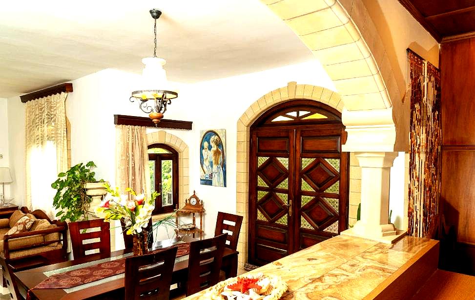 elegant dining room with arched doorways and wooden furniture