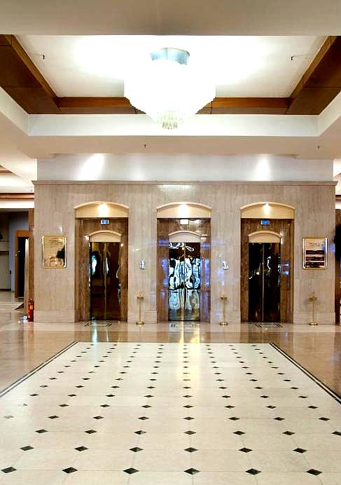 elegant lobby with marble flooring and elevator access