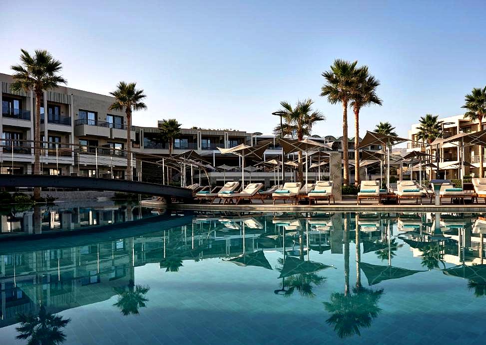 elegant poolside area with cabanas and palm trees at luxury resort