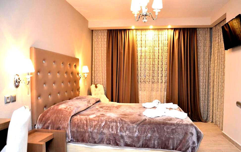 elegant room with king size bed and plush bedding